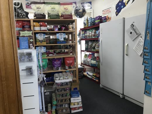 Chest freezer of raw and frozen pet food beside shelving
